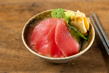 Fresh salmon sashimi don. Raw salmon roe and wasabi. Japanese food on restaurant table. Isolate on wood background