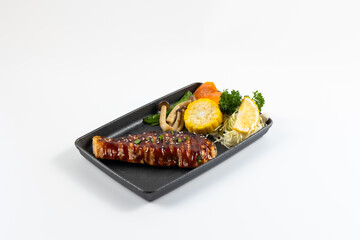 Grilled juicy pork steaks in hot pan. Top view, flat lay. Isolate on white background. Japanese food on restaurant table