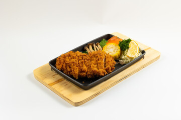 Grilled juicy pork steaks in hot pan. Top view, flat lay. Isolate on white background. Japanese food on restaurant table