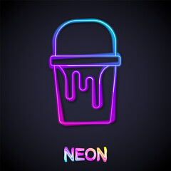 Glowing neon line Paint bucket icon isolated on black background. Vector