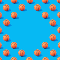 Pattern made of orange basketball on blue background with copy space. Creative sport concept.