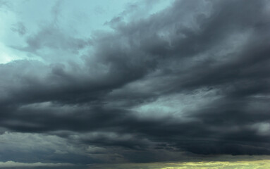 The dark sky with heavy clouds converging and a violent storm before the rain.Bad or moody weather...