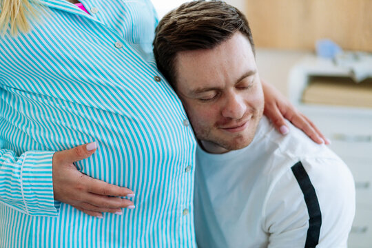 Pregnancy expecting couple belly hearing. Young couple waiting baby.