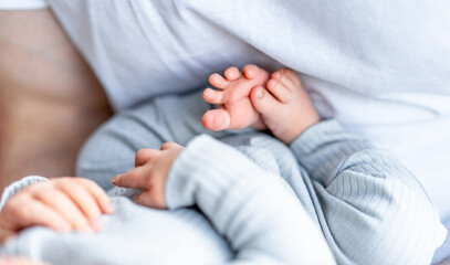 Newborn child hands and feet. Small baby fingers.