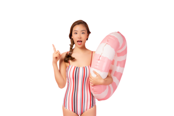 Happy young Asian woman wear swimsuit hold pink swim ring or inflatable tube ring Excited lady pointing finger up to copy space isolated on pink color background studio Summer vacation concept