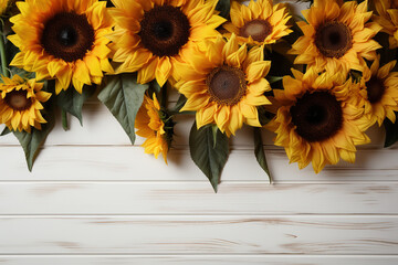 Greeting card design with Sunflowers on white wooden background. Frame for text with flowers of sunflowers. Top view. Copy space