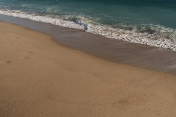 Warm day on a Cannes beach with azure waves of mediterranean sea