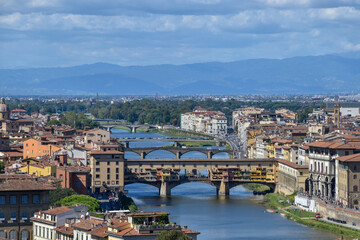Fototapeta na wymiar Bridges over the Arno River, which divides Florence into two parts. The first bridge is the Old Bridge, Ponte Vecchio.