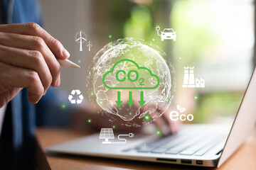 Entrepreneur hand point at digital screen dashboard while control and reduce carbon emission for global friendly business or ESG. Business with environment concern, carbon credit and zero emission.
