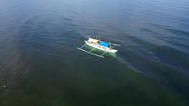 Small fishing boat floating on the sea.  Drone aerial