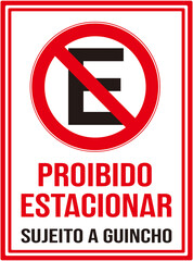 A sign that says in Portuguese language : No parking   Towing enforced