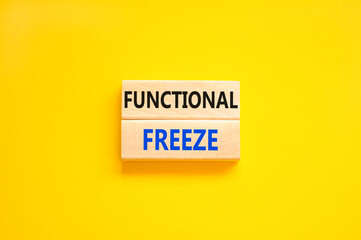 Functional freeze symbol. Concept words Functional freeze on beautiful wooden blocks. Beautiful yellow table yellow background. Business psychology functional freeze concept. Copy space.
