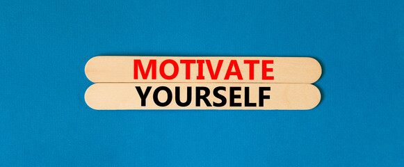 Motivate yourself symbol. Concept words Motivate yourself on beautiful wooden stick. Beautiful blue table blue background. Business psychology motivate yourself concept. Copy space.
