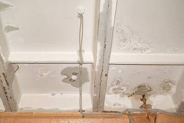 Flooding rainwater, causing damage, peeling paint and mildew.