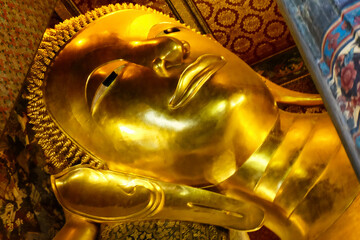 A gilded Buddha face from the Thai temple of the reclining Buddha in Bangkok.