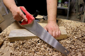 Hands with a tool on the background of a carpentry workshop. Photo in high quality. 