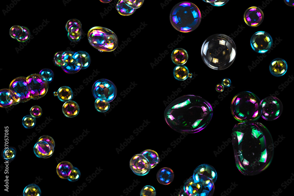 Wall mural Soap bubbles isolated on a black background