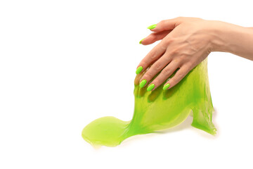 Green slime toy in woman hand with green nails isolated on a white background.