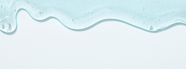 viscous pure transparent cosmetic gel on blue background. tactile , skincare, cosmetics concept....