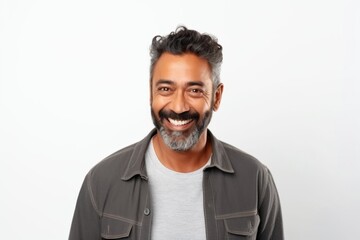Fototapeta premium Medium shot portrait of an Indian man in his 40s against a white background wearing a chic cardigan