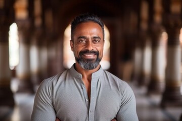 Medium shot portrait of an Indian man in his 40s in his 40s wearing a chic cardigan in a hindu temple ,