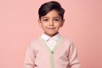 Medium shot portrait of an Indian child male against a pastel or soft colors background wearing a...