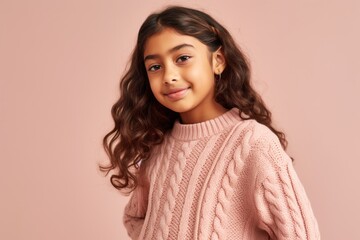 beautiful african american girl in pink sweater looking at camera