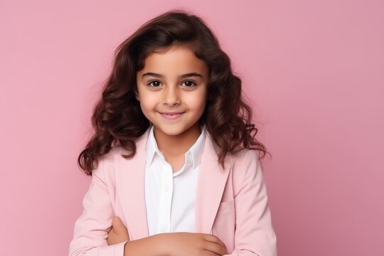 Portrait of a beautiful little girl in a pink suit on a pink background