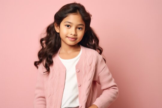 Group portrait of an Indian child female against a pastel or soft colors background wearing a cardigan
