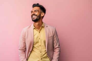 Obraz premium Young indian man over isolated pink wall laughing looking to the side