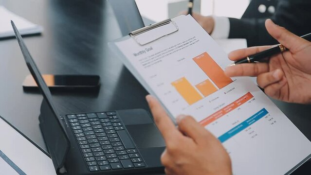 .Financial Business team present. Business man hands hold documents with financial statistic stock photo, discussion, and analysis report data the charts and graphs. Finance Financial concept
