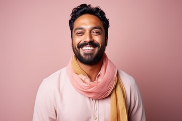 Portrait of a happy young indian man in pink scarf.