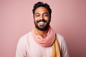 Obraz premium Portrait of a happy young indian man in pink scarf.