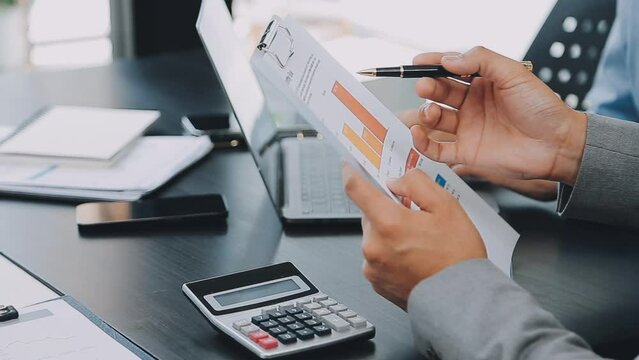 .Financial Business team present. Business man hands hold documents with financial statistic stock photo, discussion, and analysis report data the charts and graphs. Finance Financial concept