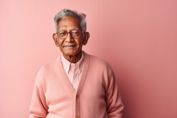 Obraz premium Portrait of a senior asian man with eyeglasses on pink background