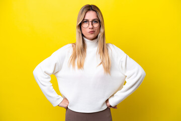 Young Uruguayan woman isolated on yellow background angry