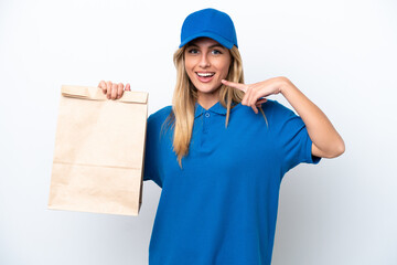 Young Uruguayan woman taking a bag of takeaway food isolated on white background giving a thumbs up gesture