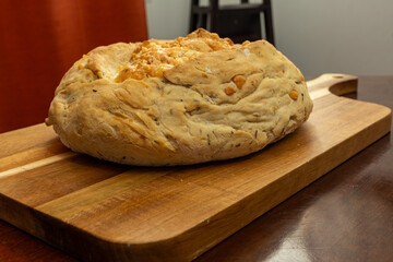 Freshly Baked Homemade Asiago Cheese Bread on a Cutting Board 