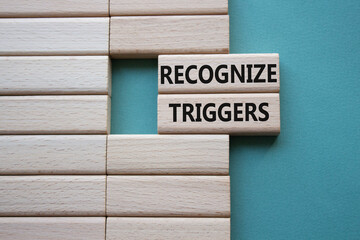 Recognize triggers symbol. Concept words Recognize triggers on wooden blocks. Beautiful grey green...