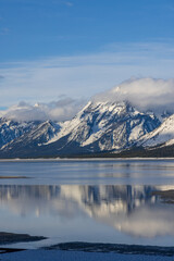 Fototapeta na wymiar Scenic Landscape Reflection of the Teton Range in Springtime in Jackson Lake