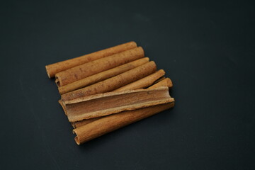 Cinnamon barks isolated on  black background , top view