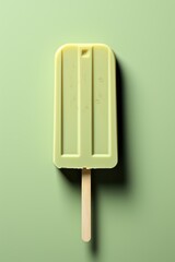 Lime vanilla popsicle on pastel green background. Natural juicy lemon icecream on a stick. Homemade mint ice cream dessert. Modern summer concept. Place for text