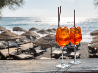 two aperol spritz on a summer evening in a mediterranean beach bar - obrazy, fototapety, plakaty