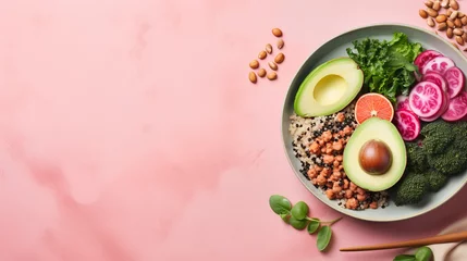  Vegan Buddha or poke bowl salad with buckwheat, vegetables and seeds on pink background © petrrgoskov