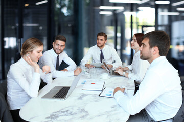 Top view of business people working together while spending time in the office.