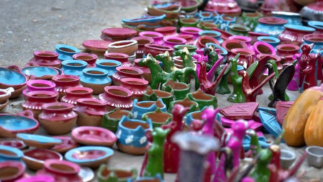 A colorful array of clay toys is displayed in a shop at a village fair in Bangladesh. Parents and children alike are drawn to the shop, their eyes sparkling with excitement and joy. 