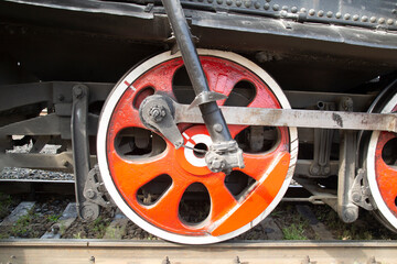 An old steam locomotive of the early 20th century on the railway track.