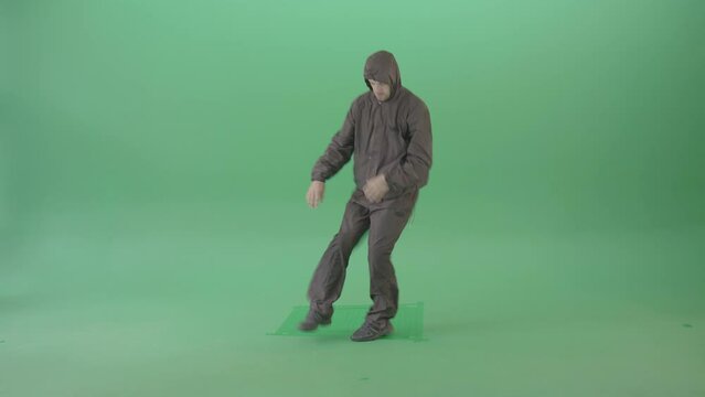 Breakdancer making power move spinning on head dancing in green screen studio 4K Video Footage