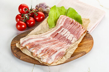 Sliced pork bacon oved board