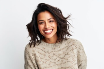 Lifestyle portrait of an Indian woman in her 30s against a white background
